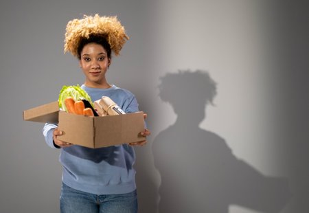 Photograph of a woman holding a box of food