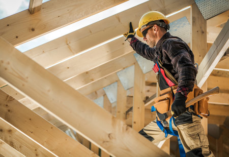 Photograph of a worker in protective clothing installing wooden roof beams in a new house